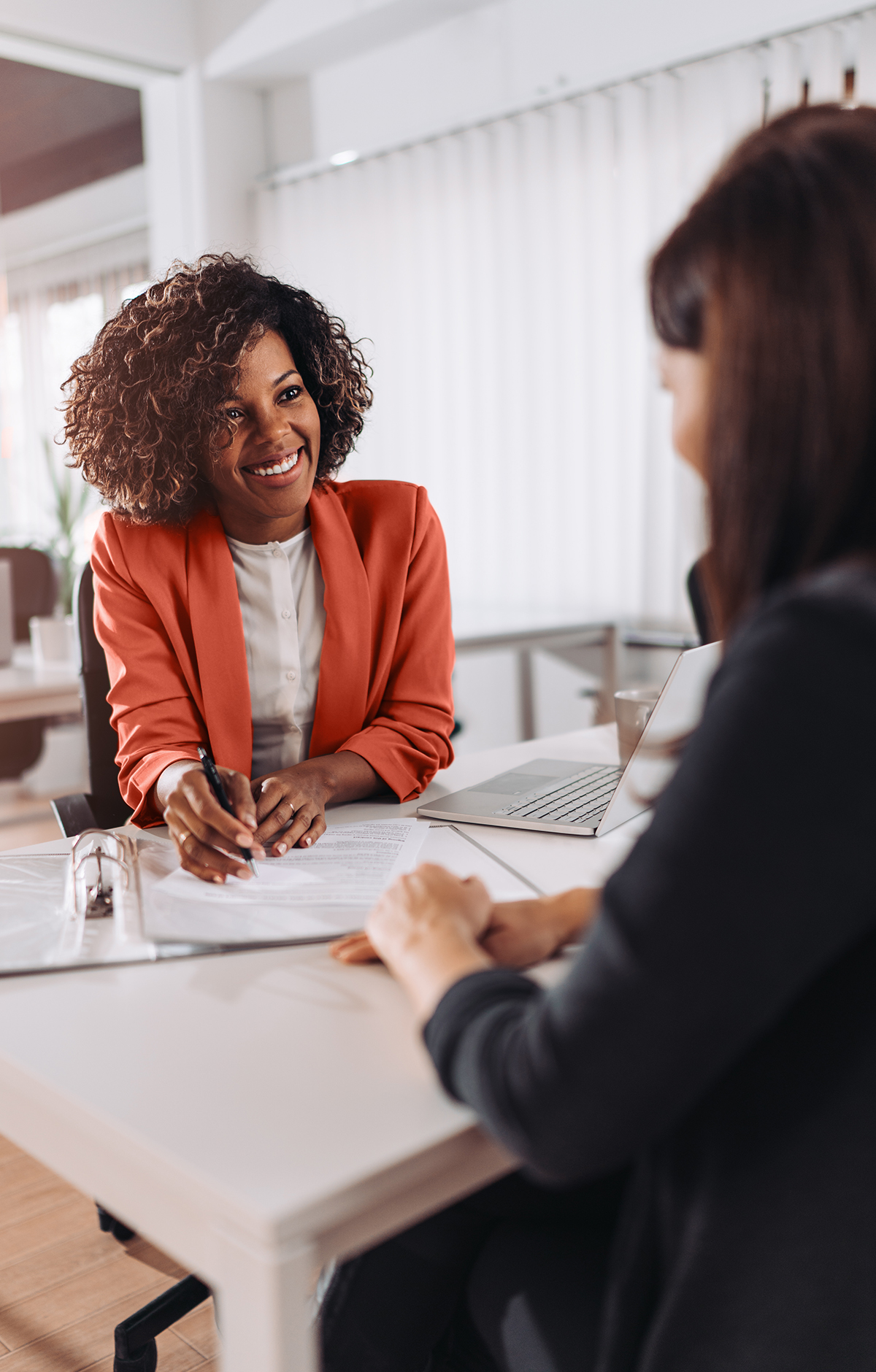 A confident female legal professional talking with a client
